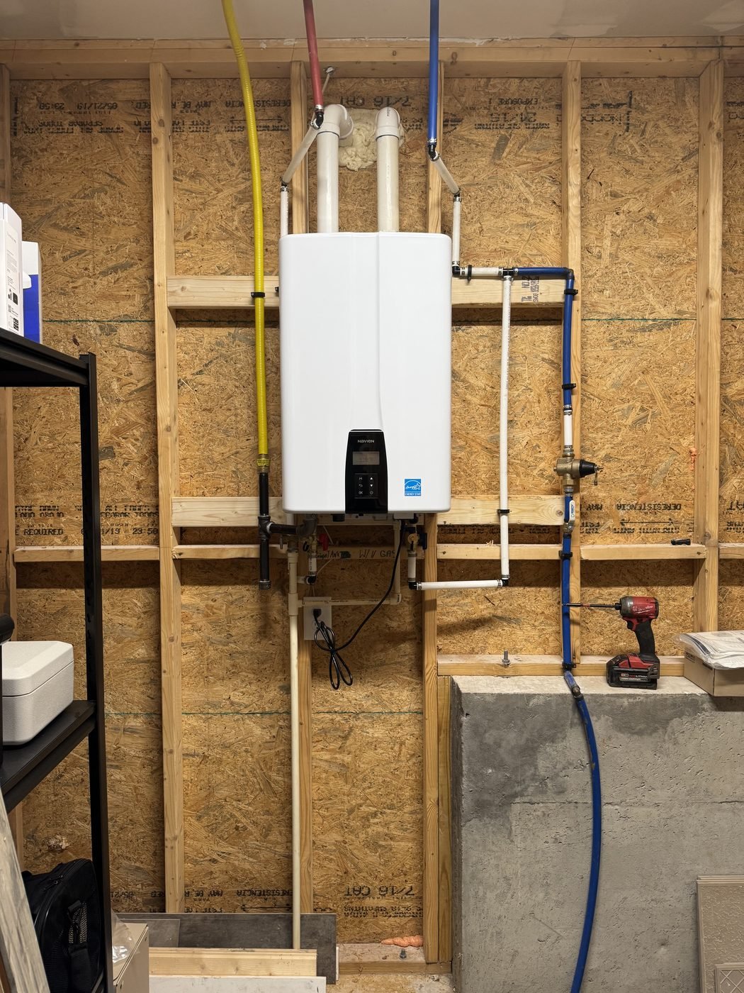 After: a wall-mounted tankless water heater installed by Johnson Brothers Plumbing